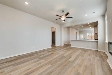 Unfurnished living room featuring recessed lighting, light wood finished floors, and ceiling fan