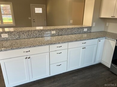 Kitchen featuring kitchen peninsula, dark wood-typ