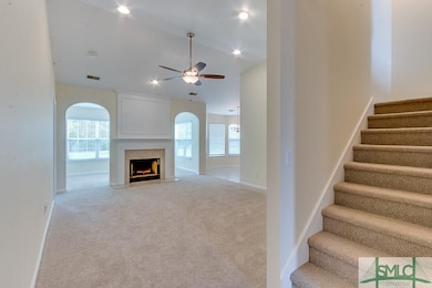 Stairs offset from foyer leading to living room