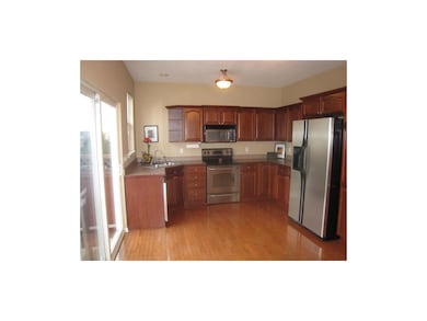 Gorgeous kitchen with cherry wood cabinetry, stain