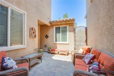 View of patio with a gate and an outdoor living sp