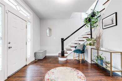 Foyer featuring plenty of natural light and dark h