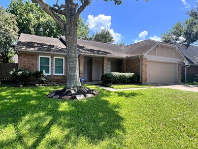 Another view of the front of the house framed by a majestic shade tree, adding to the great curb appeal.