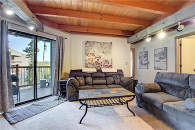 Living room with beamed ceiling, wooden ceiling, a