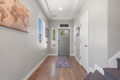 Foyer featuring hardwood / wood-style floors and baseboards