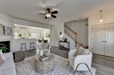 Living area featuring ceiling fan, wood finished f