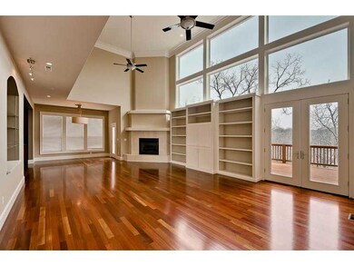 Living Room. Expansive living area w/gleaming wood floors, media storage/display, fireplace.