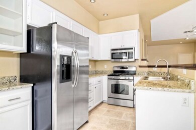 Spacious kitchen has been upgraded with slab grani