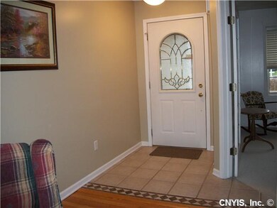 Foyer. Covered front porch leads into ceramic tile