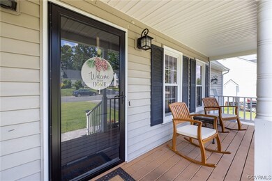 View of exterior entry featuring covered porch