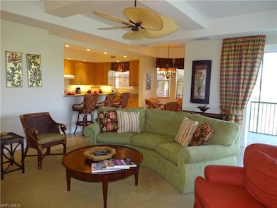 Carpeted living room with beamed ceiling and ceili