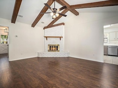 Unfurnished living room featuring a fireplace, woo
