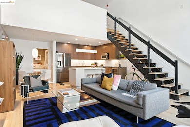 Living area with light wood-style floors, stairway, a high ceiling, beverage cooler, and recessed lighting