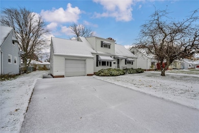 View of front of house with an attached garage and roof with shingles