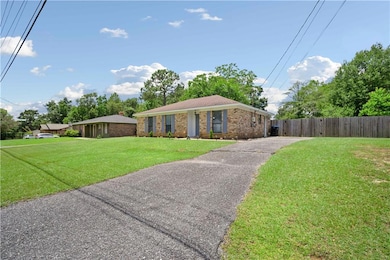 Single story home with brick siding and driveway