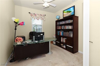 Home office with baseboards, light colored carpet,