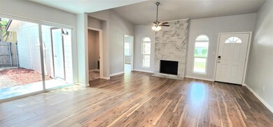 Unfurnished living room with ceiling fan, hardwood