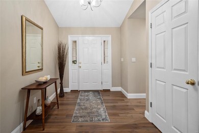 Entry foyer boasts vaulted ceiling, updated lighti