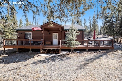 View of front of house featuring a deck, a shingled roof, and log veneer siding