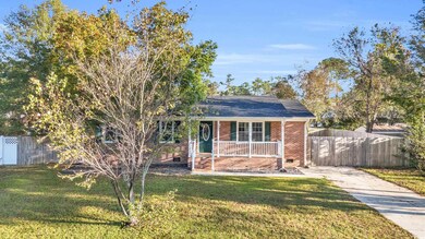 View of front of house with a porch and a front la