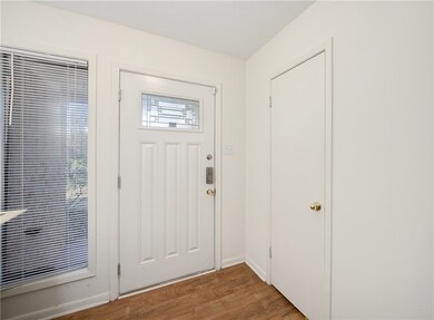 Entryway with baseboards and wood finished floors