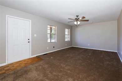 Spare room featuring baseboards and a ceiling fan