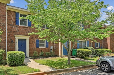 View of front of home with brick siding and a front yard