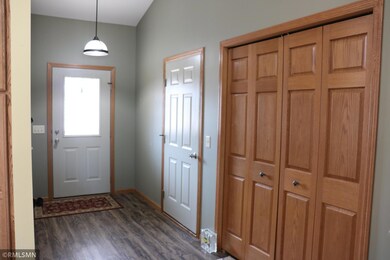 Spacious foyer with garage and hall coat closet.