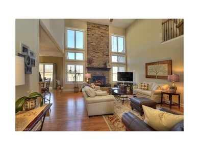 Hardwood flooring and a Wall of Windows flanking a