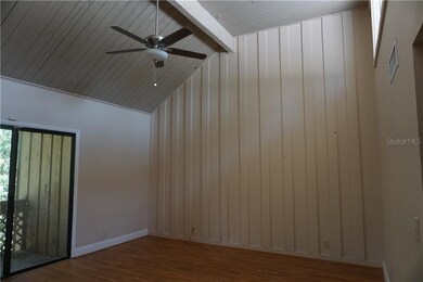 Living room has vaulted ceiling and new ceiling fa