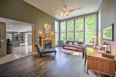 Living room with gas fireplace and lots of windows