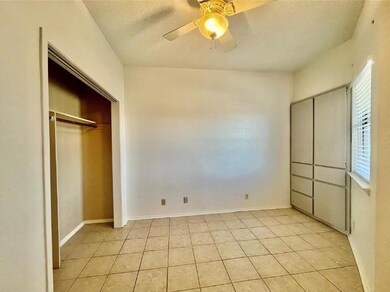 Unfurnished bedroom with a textured ceiling, ligh