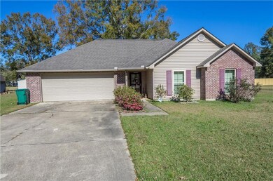 Double car garage and long paved driveway.