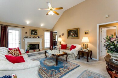 Extra large living room with vaulted ceilings and fireplace.