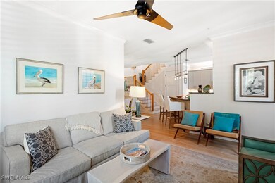 Living area with light wood finished floors, stair
