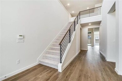 Stairway featuring a high ceiling and dark hardwoo