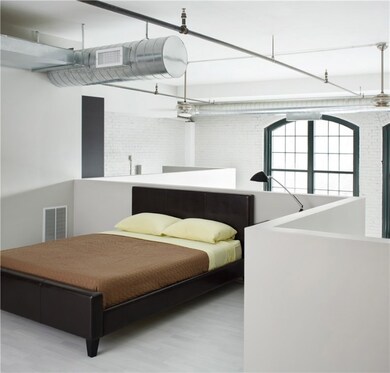 The master bedroom has a half wall and looks out o