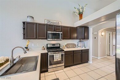 Kitchen with arched walkways, appliances with stai