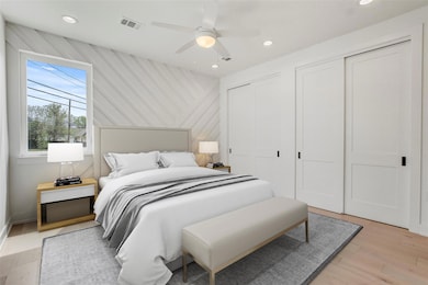 Bedroom with multiple closets, recessed lighting,