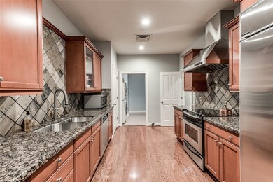 The galley-style kitchen, situated off the hallway and formal dining room, boasts elegant cherry wood cabinets, complemented by gleaming granite countertops and stainless steel appliances. Included in the lease are all appliances, making it convenient for your immediate use.