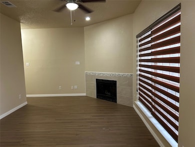 Unfurnished living room featuring dark wood-type f