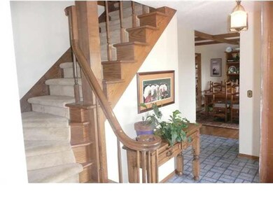 Open wood staircase in foyer.