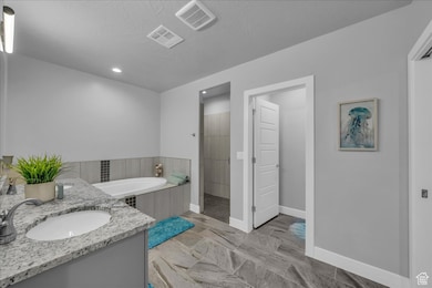 Full bathroom featuring a bath, recessed lighting, vanity, and a tile shower