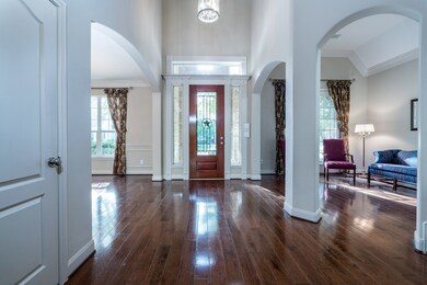 Architectural details include high ceilings, arched walkways, a Texas star leaded glass door with transom window above and sidelights that flank each side!