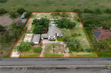 Aerial view of property and surrounding area with property boundaries highlighted