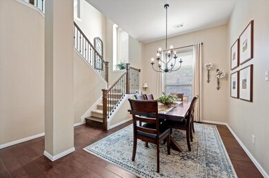 Dining area featuring a chandelier and dark wood-t