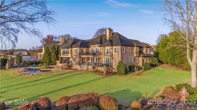 Expansive backyard with mature plantings and fence