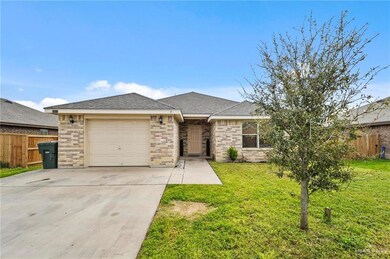 View of front facade with a front yard and a garage