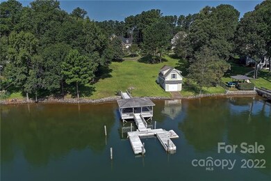 Private pier with covered seating and boat slip. B