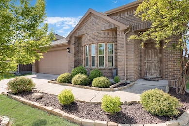 Front of the house featuring a garage, brick sidin